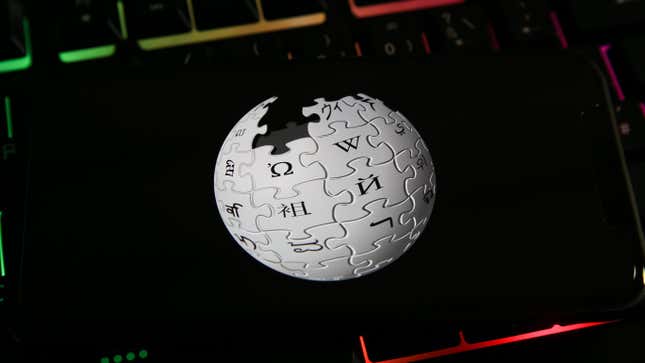 A phone with the Wikipedia globe logo on top of the LED keyboard keys.
