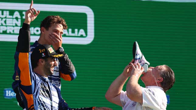 McLaren CEO Zak Brown drinks from Daniel Ricciardo's shoe on the Monza podium.