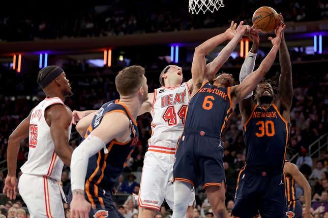 Mar 29, 2023; New York, New York, USA; New York Knicks forward Julius Randle (30) and guard Quentin Grimes (6) and center Isaiah Hartenstein (55) fights for a rebound against Miami Heat center Cody Zeller (44) and forward Jimmy Butler (22) during the first quarter at Madison Square Garden.