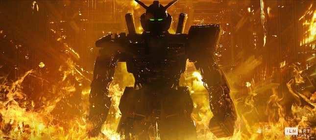 A giant Gundam robot, shadowed by fire, walks away downs a futuristic hall.