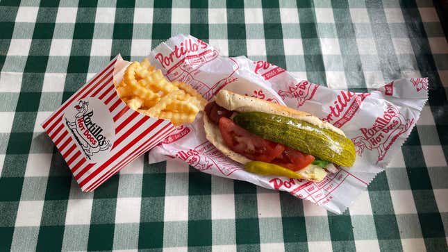 Portillo's plant-based hot dog and fries on checkerboard tablecloth