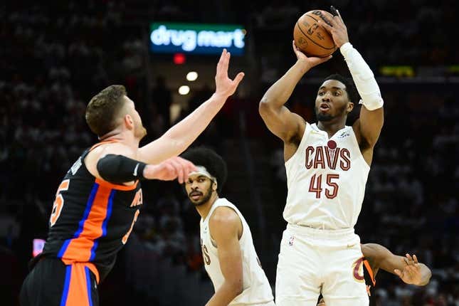 Apr 18, 2023; Cleveland, Ohio, USA; Cleveland Cavaliers guard Donovan Mitchell (45) shoots over the defense of New York Knicks center Isaiah Hartenstein (55) during the second half of game two of the 2023 NBA playoffs at Rocket Mortgage FieldHouse.