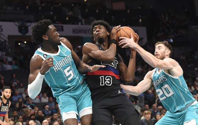 Feb 27, 2023; Charlotte, North Carolina, USA; Detroit Pistons center James Wiseman (13) gets a rebound from Charlotte Hornets center Mark Williams (5) and forward Gordon Hayward (20) during the second half at the Spectrum Center.