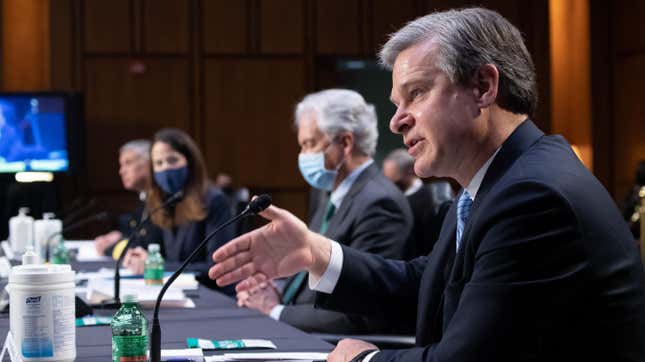 FBI Director Christopher Wray (R) testifies during a Senate Select Committee on Intelligence hearing about worldwide threats, on Capitol Hill in Washington, DC, April 14, 2021.