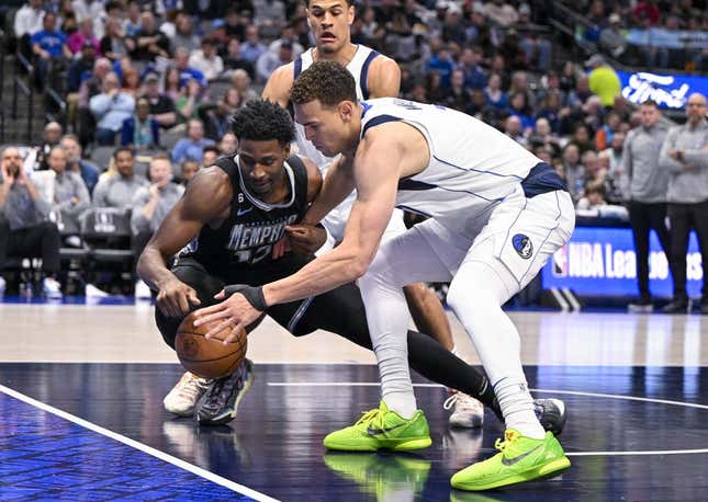 Mar 13, 2023; Dallas, Texas, USA; Memphis Grizzlies forward Jaren Jackson Jr. (13) and Dallas Mavericks center Dwight Powell (7) battle for control of the loose ball during the second quarter at the American Airlines Center.