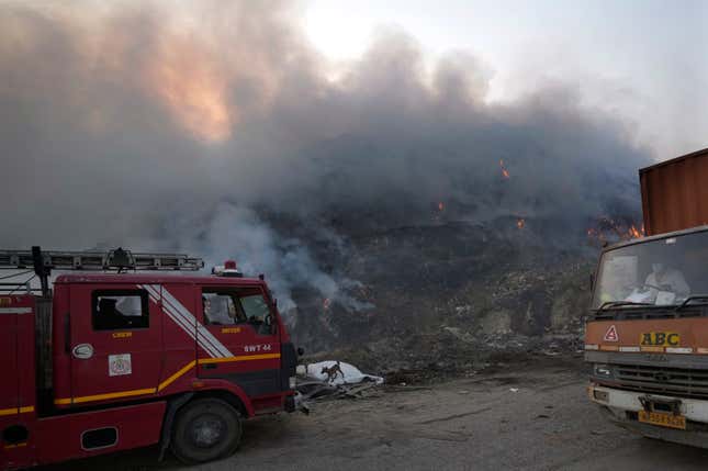 A Delhi fire tender waits during a fire at the Bhalswa landfill in New Delhi, India, Wednesday, April 27, 2022.