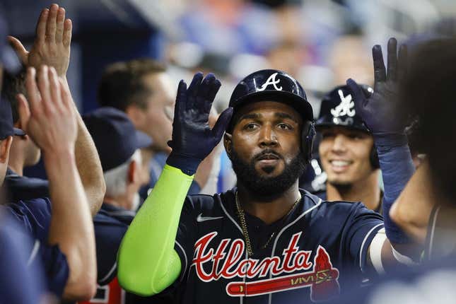 May 3, 2023; Miami, Florida, USA; Atlanta Braves designated hitter Marcell Ozuna (20) celebrates with teammates after hitting a grand slam during the second inning against the Miami Marlins at loanDepot Park.