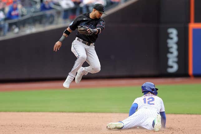 Apr 7, 2023; New York City, New York, USA; New York Mets shortstop Francisco Lindor (12) steals second base as the ball goes by Miami Marlins second baseman Luis Arraez (3) allowing Lindor to advance to third during the sixth inning at Citi Field.
