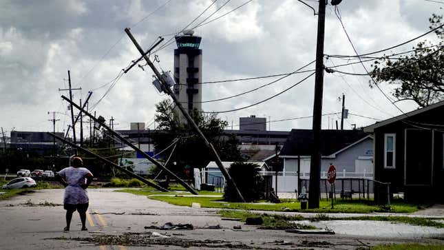A woman looks over damage to a neighborhood caused by Hurricane Ida on Aug. 30, 2021 in Kenner, Louisiana.