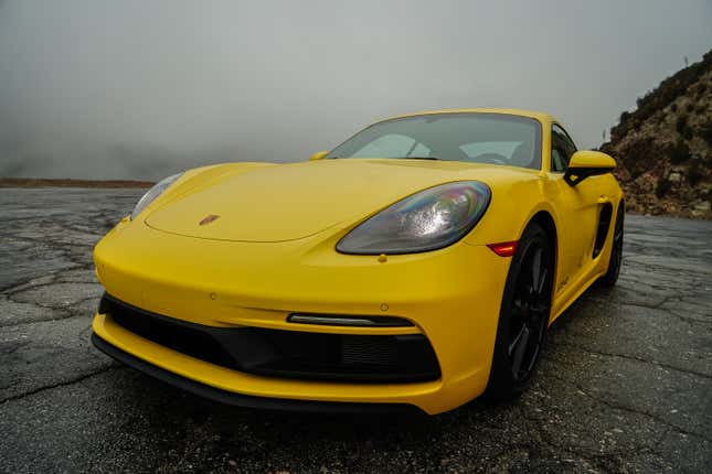 Front three-quarter view of the yellow Porsche Cayman GTS 4.0 2022