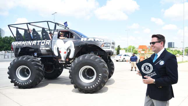 Michael Empric, Adjudicator for Guinness World Records, RAM counts trucks as they pass by to determine if RAM will break the Guinness World Records for the largest parade of RAM vehicles and the largest parade of pickup trucks during the RAM truck Round-Up at AT&T Stadium on April 18, 2015 in Dallas, Texas. 