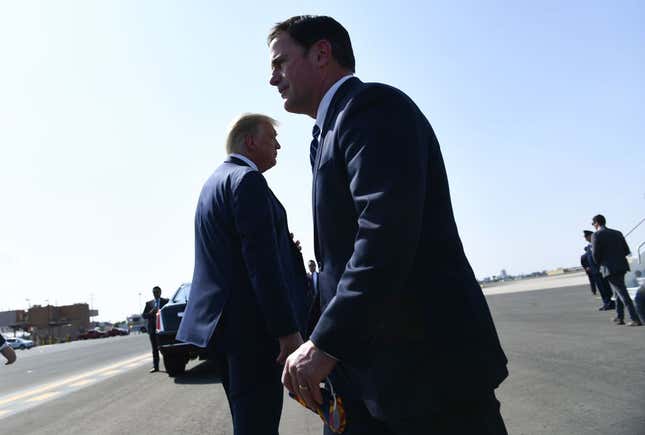 U.S. President Donald Trump and Arizona governor Doug Ducey (R) are seen on the tarmac after Air Force One landed in Phoenix, Arizona, on September 14, 2020. 