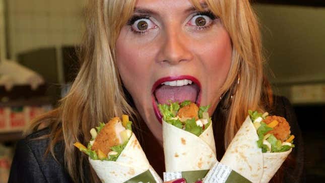 Heidi Klum poses with three McDonald's snack wraps