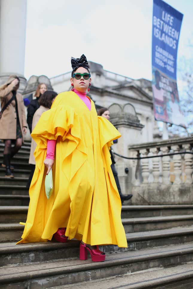  A Guest is seen wearing a Yellow Dress at Roksanda, during London Fashion Week February 2022 on February 21, 2022 in London, England. 