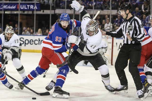 Feb 26, 2023; New York, New York, USA;  New York Rangers center Mika Zibanejad (93) and Los Angeles Kings center Anze Kopitar (11) battle for control of the puck following a face off in the first period at Madison Square Garden.