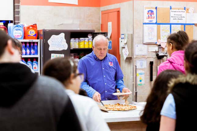 Tom Benson serves pizza from the front counter on a busy Wednesday evening.
