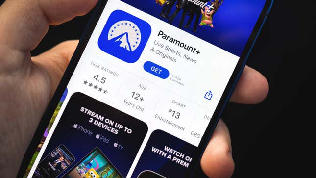 man holding smartphone with paramount plus app opened