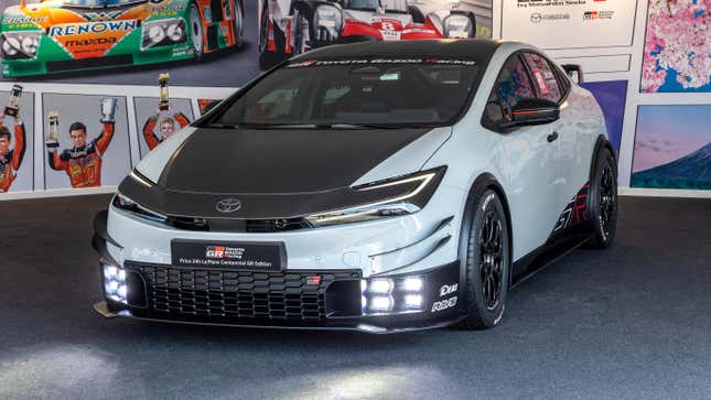 A Prius 24h Le Mans Centennial GR Edition from the front with its headlights turned on.