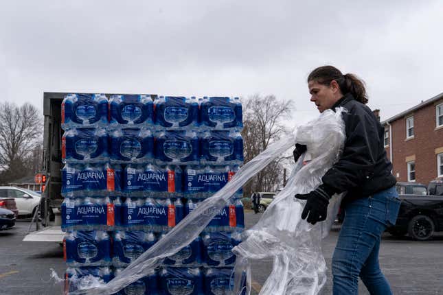 Cortney Wischerman volunteers to distribute cases of water to residents on February 17, 2023 in East Palestine, Ohio.