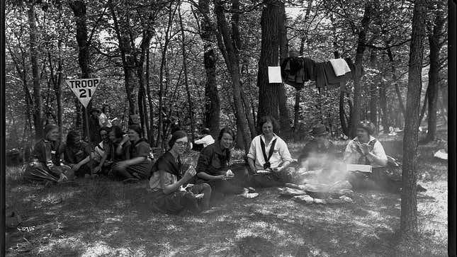 Minnesota girl scouts sitting around a campfire
