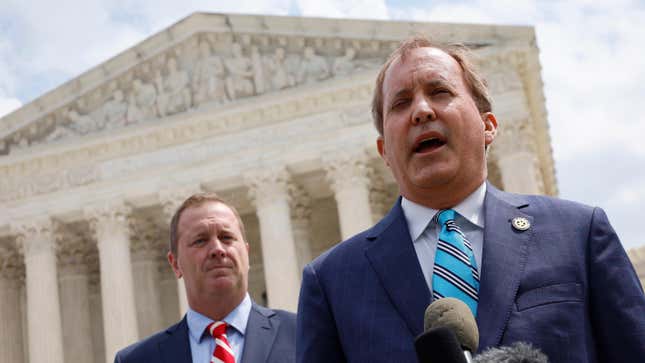 Texas Attorney General Ken Paxton (R) and Missouri Attorney General Eric Schmitt talk to reporters after the U.S. Supreme Court heard arguments in their case about Title 42 on April 26, 2022 in Washington, DC. 