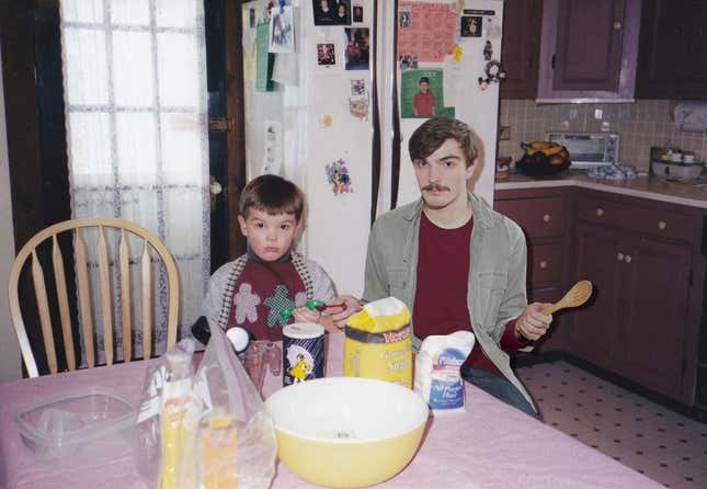 Young Nickerson and adult Nickerson looking baffled trying to make cookies.