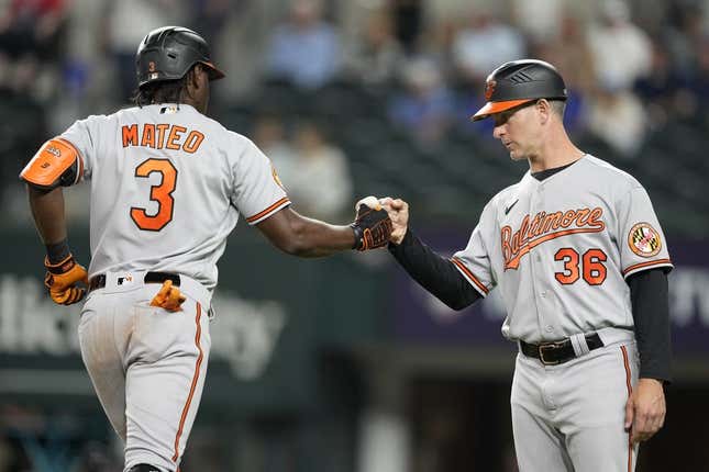 Apr 3, 2023; Arlington, Texas, USA; Baltimore Orioles shortstop Jorge Mateo (3) celebrates his solo home run with third base coach Tony Mansolino (36) against the Texas Rangers during the fifth inning at Globe Life Field.