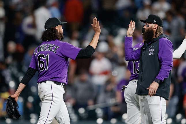 Apr 10, 2023; Denver, Colorado, USA; Colorado Rockies relief pitcher Justin Lawrence (61) reacts with designated hitter Charlie Blackmon (19) after the game against the St. Louis Cardinals at Coors Field.