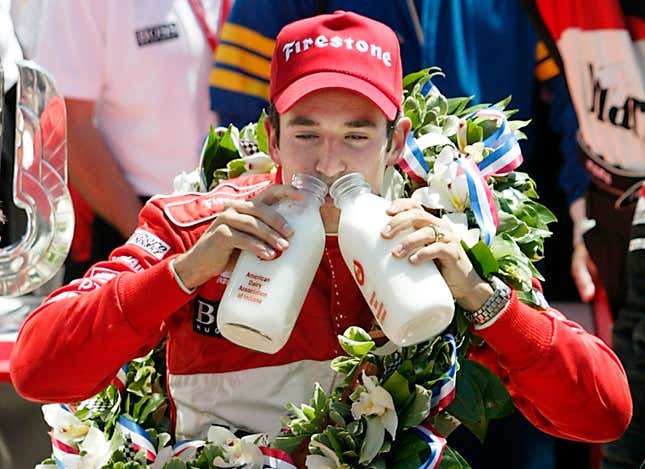 Helio Castroneves celebrates winning back-to-back Indy 500s by drinking from two milk glasses. May 26, 2002.