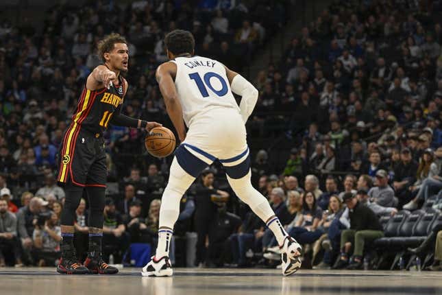 Mar 22, 2023; Minneapolis, Minnesota, USA;  Atlanta Hawks guard Trae Young (11) calls a play as Minnesota Timberwolves guard Mike Conley (10) defends in the second quarter at Target Center.