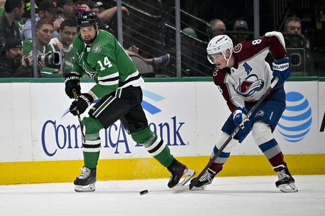 Mar 4, 2023; Dallas, Texas, USA; Dallas Stars left wing Jamie Benn (14) passes the puck in front of Colorado Avalanche defenseman Cale Makar (8) during the first period at the American Airlines Center.