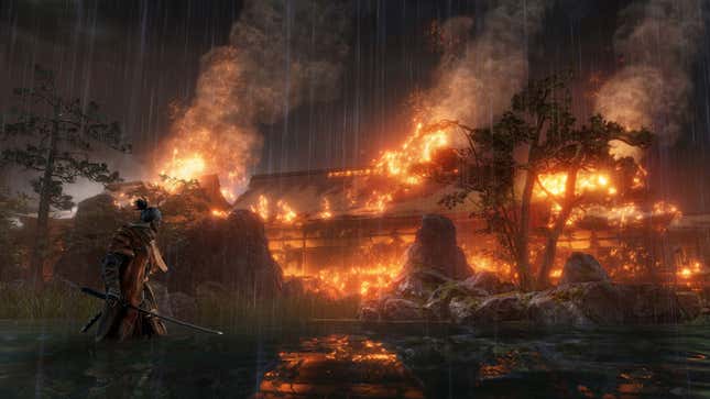Sekiro standing in front of a burning building. 