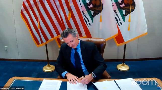 This image made from video from the Office of the Governor shows California Gov. Gavin Newsom signing into law a bill that establishes a task force to come up with recommendations on how to give reparations to Black Americans on Sept. 30, 2020, in Sacramento, Calif.
