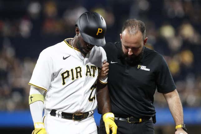Sep 4, 2023; Pittsburgh, Pennsylvania, USA;  Pittsburgh Pirates designated hitter Andrew McCutchen (22) is helped from the field after suffering an apparent injury against the Milwaukee Brewers during the fifth inning at PNC Park.