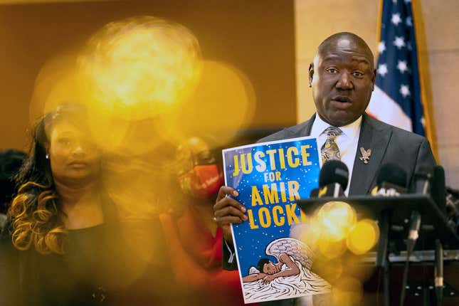 Civil rights attorney Ben Crump (R) holds a sign reading “Justice for Amir Locke” during a news conference with families who lost their loved ones to police violence to demand the abolishment of no-knock warrants and justice for the victims at the Minnesota State Capitol in Saint Paul, Minnesota on February 10, 2022. (Photo by Kerem Yucel / AFP) (Photo by KEREM YUCEL/AFP via Getty Images)