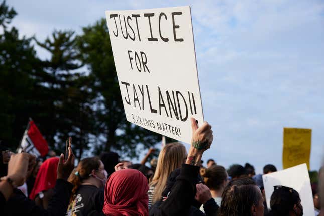 A demonstrator holds a sign during a vigil in honor of Jayland Walker on July 8, 2022 in Akron, Ohio. Walker was shot and killed by members of the Akron Police Department on July 3, 2022. 