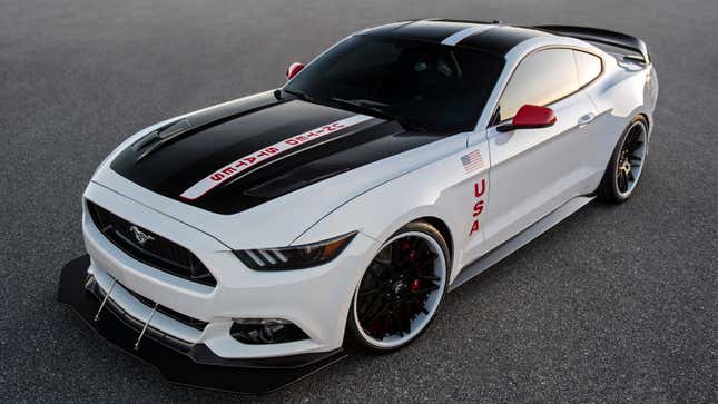 A photo of a white Ford Mustang with USA badges. 
