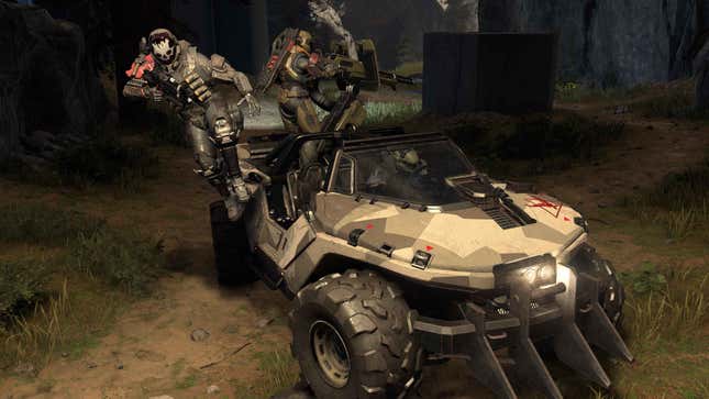 Three spartan soldiers drive a warthog in Halo Infinite's big team battle mode.