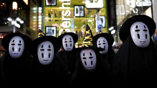 Halloween goers dressed up as No-Face. 