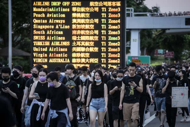 Protesters walk on a highway near Hong Kong’s airport following a protest against police brutality, Aug. 12, 2019.