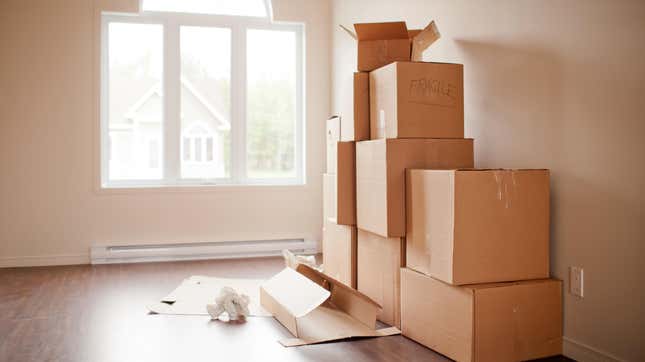 Stacks of moving boxes in a sunny room