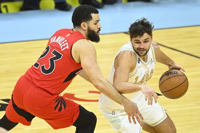 Dec 23, 2022; Cleveland, Ohio, USA; Cleveland Cavaliers guard Raul Neto (19) dribbles beside Toronto Raptors guard Fred VanVleet (23) in the third quarter at Rocket Mortgage FieldHouse.