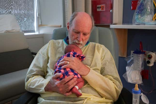 Volunteer cuddler John Myers holds Story at Winchester Medical Center.