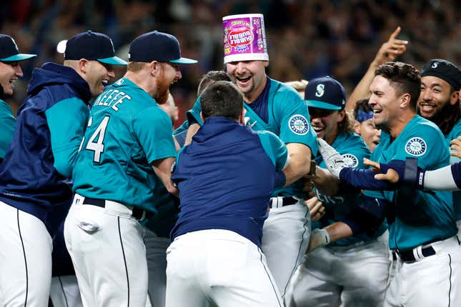 Cal Raleigh of the Seattle Mariners celebrates his walk-off home run during the ninth inning against the Oakland Athletics at T-Mobile Park on September 30, 2022 in Seattle, Washington. With the win, the Seattle Mariners have clinched a postseason appearance for the first time in 21 years, the longest playoff drought in North American professional sports