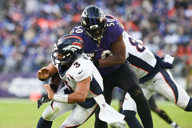 Dec 4, 2022; Baltimore, Maryland, USA;Baltimore Ravens linebacker Justin Houston (50) hits Denver Broncos quarterback Russell Wilson (3)  during the second half  at M&amp;amp;T Bank Stadium.