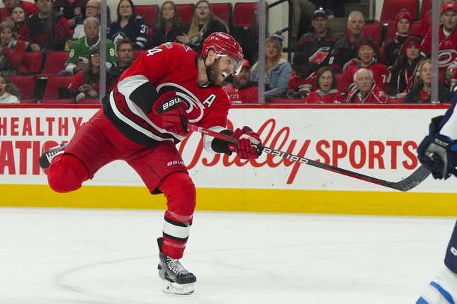 Mar 14, 2023; Raleigh, North Carolina, USA; Carolina Hurricanes defenseman Jaccob Slavin (74) shoots against the Winnipeg Jets during the first period at PNC Arena.