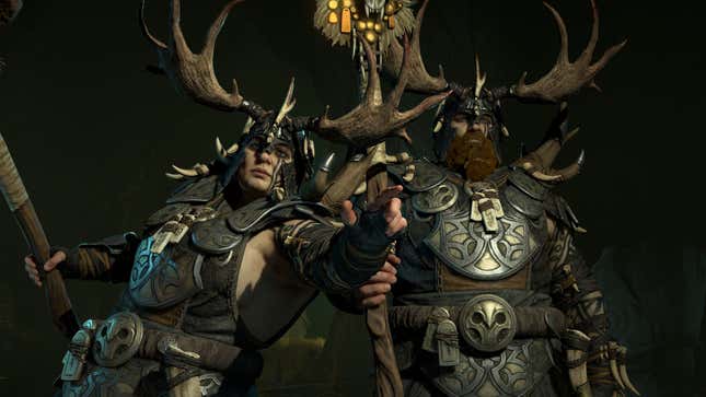 Two Druid characters are seen in a dark area with weapons drawn.