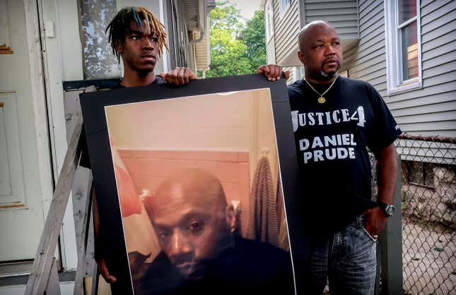 Armin Prude, left, and Joe Prude hold an enlarged photo of Daniel Prude, Sept. 3, 2020, who died following a police encounter, in Rochester, N.Y. City officials have agreed to pay $12-million to the family of Daniel Prude, a Black man who died after police held him down until he stopped breathing after encountering him running naked through the snowy streets of Rochester, NY. A federal judge approved the settlement in a court document filed Thursday, Oct. 6, 2022. 