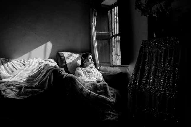 Zeenat, a woman from a traditional family in Lucknow, wears a real Mukaish dress made out of gold and silver wires, crafted at the time of the Nawabs in the 18th century. Around her are a variety of Mukaish apparels.