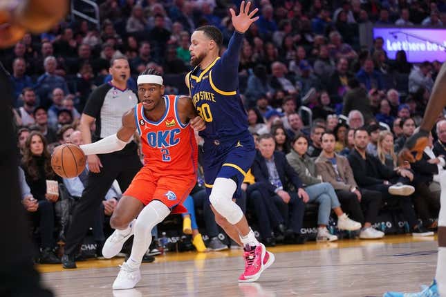 Apr 4, 2023; San Francisco, California, USA; Oklahoma City Thunder guard Shai Gilgeous-Alexander (2) dribbles the ball next to Golden State Warriors guard Stephen Curry (30) in the second quarter at the Chase Center.